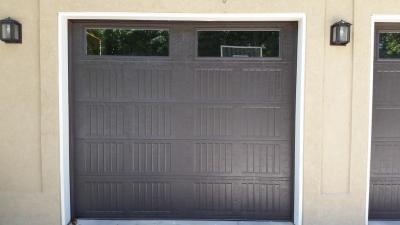 Dark Brown Carriage Style garage door with decorative windows